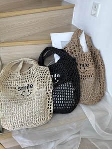 Detailed knit texture of hollow straw beach bags in beige black and brown with smile logo