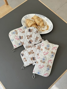 Quilted beige cosmetic pouches with cute bear and dog prints and silver zippers