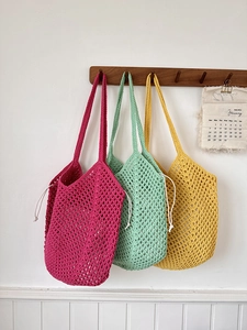 Handwoven hollow cotton rope tote bags in magenta, mint green, and ginger yellow colors