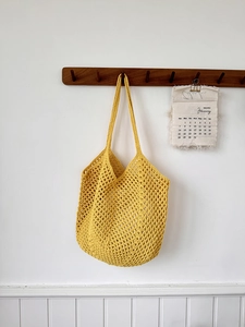 Detailed view of yellow crochet cotton shoulder bag with hollow diamond mesh texture