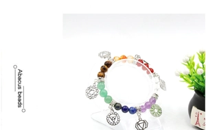 Detail of colorful chakra energy bracelet with abacus beads and silver yoga pendants