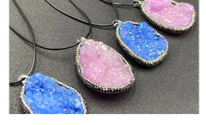 Détail de pendentifs druzy colorés en forme de goutte d'eau avec des strass brillants