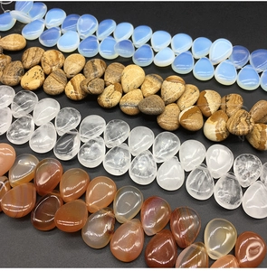 Polished teardrop natural stones in various colors including blue, brown and crystal quartz