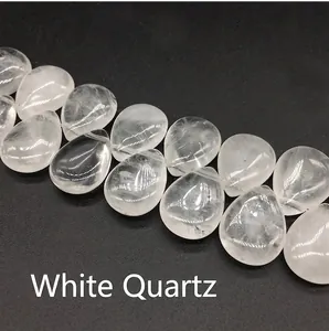 Macro detail of transparent teardrop clear quartz beads showing natural icy textures