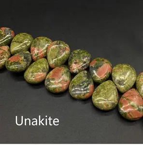 Macro detail of teardrop Unakite beads showing natural green and red marble texture