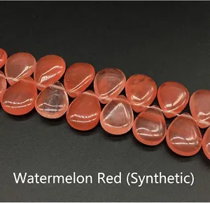 Macro detail of watermelon red teardrop crystal beads with translucent internal texture