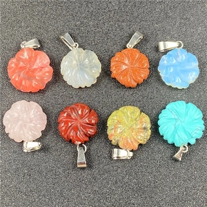 Close-up of eight multicolored carved stone flower pendants with silver metal clasps