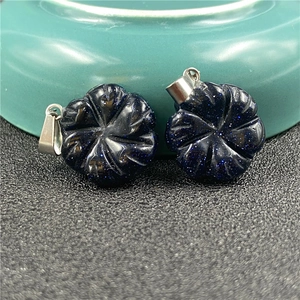 Macro detail of blue sandstone flower pendants with shimmering gold speckles on silver clips