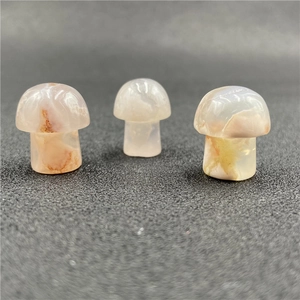 Three hand-polished natural agate mushroom figurines with unique earthy brown textures