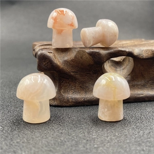 Set of four natural agate mushroom figurines on a wooden base for home desk decoration