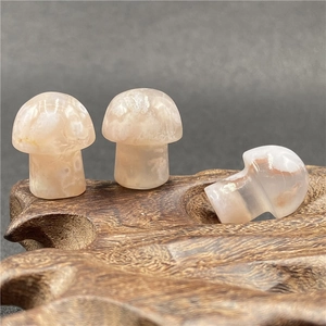 Detailed view of three polished agate mushroom figurines with natural floral textures