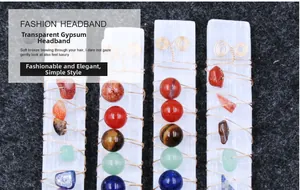 Close-up of wire-wrapped selenite wand with various natural colorful crystal gemstones