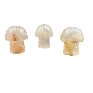 Set of three hand-carved agate mushroom figurines with natural translucent stone textures