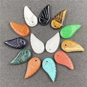 Macro view of multi-color carved angel wing pendants for DIY bracelet making