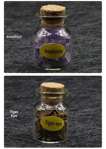 Detailed shot of amethyst and tiger eye crystals in glass bottles with cork stoppers