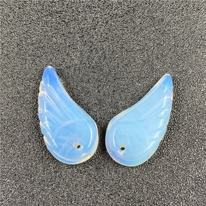 Detailed view of translucent blue opal angel wing charms with delicate feather textures