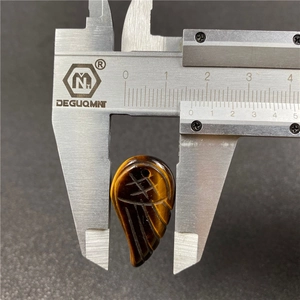 Macro shot measuring 15mm tiger eye stone angel wing pendant with digital caliper