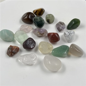 Polished tumbled healing stones in various colors like tiger eye and amethyst
