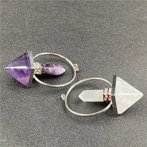Macro detail of natural amethyst and quartz pendants with ornate silver metal link