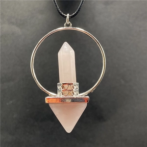Close-up of rose quartz hexagonal pillar and triangle pendant with black cord