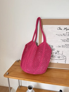 Detail of rose red hollow hand-woven cotton rope tote bag with long shoulder strap