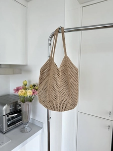 Detailed close-up of khaki woven cotton rope bag featuring a hexagonal mesh pattern