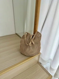 Close-up of a hollow woven cotton rope bag in beige with detailed mesh craftsmanship