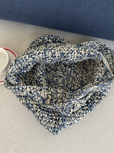 Handwoven straw tote bag with blue and beige texture, perfect for beach and summer travel