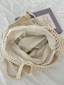 Chic beige handmade hollow crochet tote bag with inner lining on white background cloth