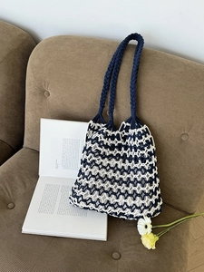 Handmade woven hollow knit shoulder bag in navy and beige for beach and vacation use