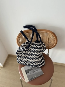 Detail view of bicolor hand-woven mesh tote bag featuring a durable thick-strap handle