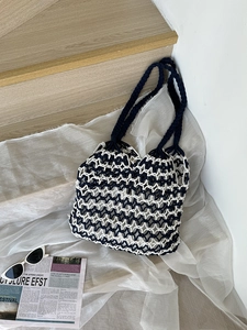 Handmade woven tote bag with black and white knit pattern for casual beach vacations