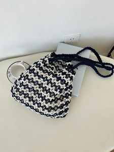 Detail of navy and beige hand-crocheted shoulder bag with star-shaped hollow patterns