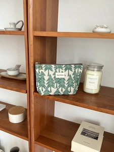 Close-up of cotton linen makeup bag with pine tree embroidery and vintage zipper pull