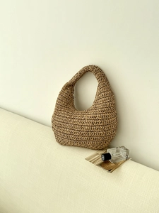Detail of hand-woven cloud shoulder bag showing natural plant fiber texture and hobo style