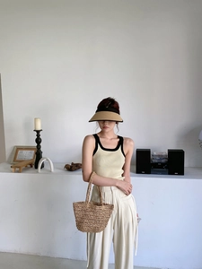 Chic summer set with straw tote bag, knitted tank top, and sun hat for beach vacations