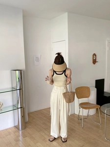 Minimalist summer vacation outfit featuring a straw handbag and matching sun hat