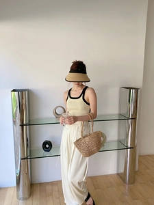 Chic summer set with straw sun hat, knit tank top, and woven tote bag on a model