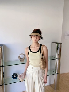 Chic summer look with woven straw handbag and knit vest for seaside beach vacations