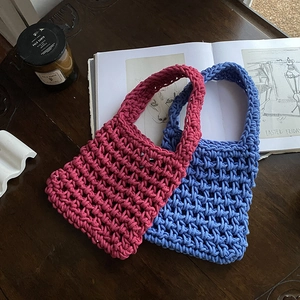 Handmade woven cotton rope mini tote bags in rose red and blue-purple on wooden desk
