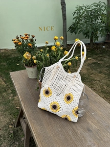 Detail of sunflower crochet tote bag with fringe tassels and wooden bead accent