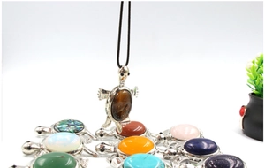 Macro detail of various turtle pendants featuring natural tiger eye and turquoise stones