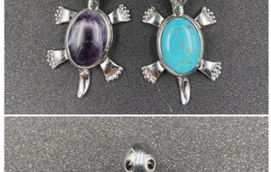 Macro detail showing turtle shell pendant with natural purple crystal and turquoise stones