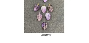 Makro-Detail von handgeschnitzten Amethyst-Blattanhängern mit Ösen für DIY-Schmuckherstellung