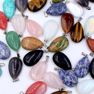 Various teardrop natural stone pendants with silver metal clasps on white background