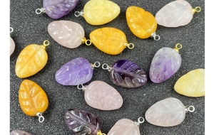 Detailed carved leaf-shaped amethyst and rose quartz pendants with metal loops