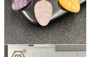 Macro detail of leaf-shaped amethyst and rose quartz pendants showing vein textures