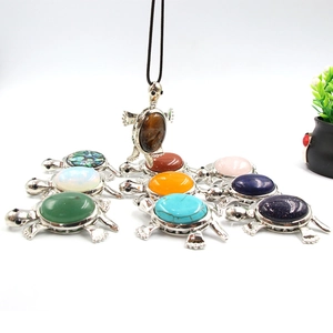 Natural stone turtle pendant with varied semi-precious gems and black lanyard cord