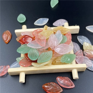 Detailed macro view of colorful leaf-shaped resin beads for DIY jewelry making