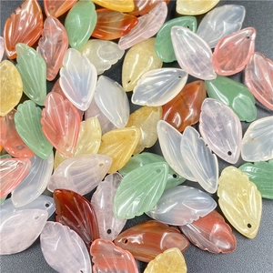 Detailed view of natural carved stone petals and leaf charms for DIY jewelry making